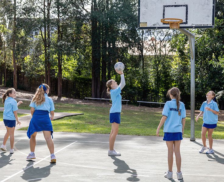 Five girls playing basketball